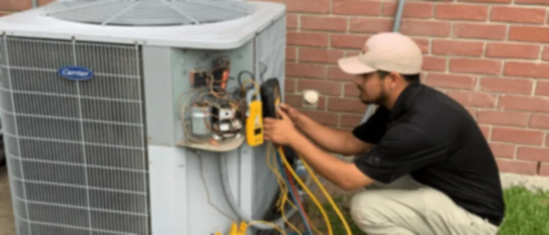 A Katy Plumbing Company technician servicing an air conditioning condenser